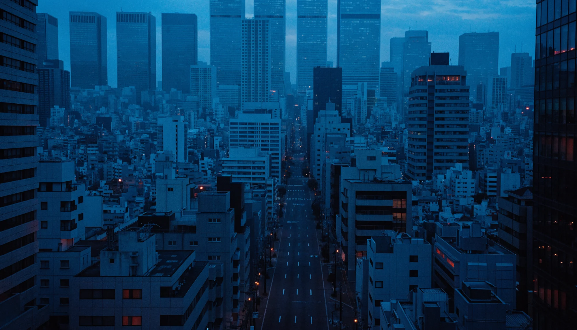A conceptual Tokyo-like skyline at blue hour, with dense blue buildings and scattered warm red lights.